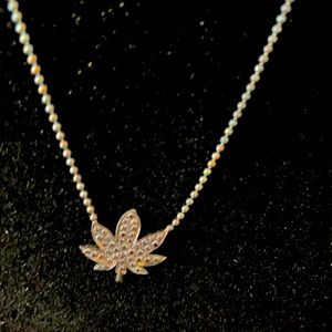 Oxidized silver hemp leaf necklace by Fisou jewelry.
